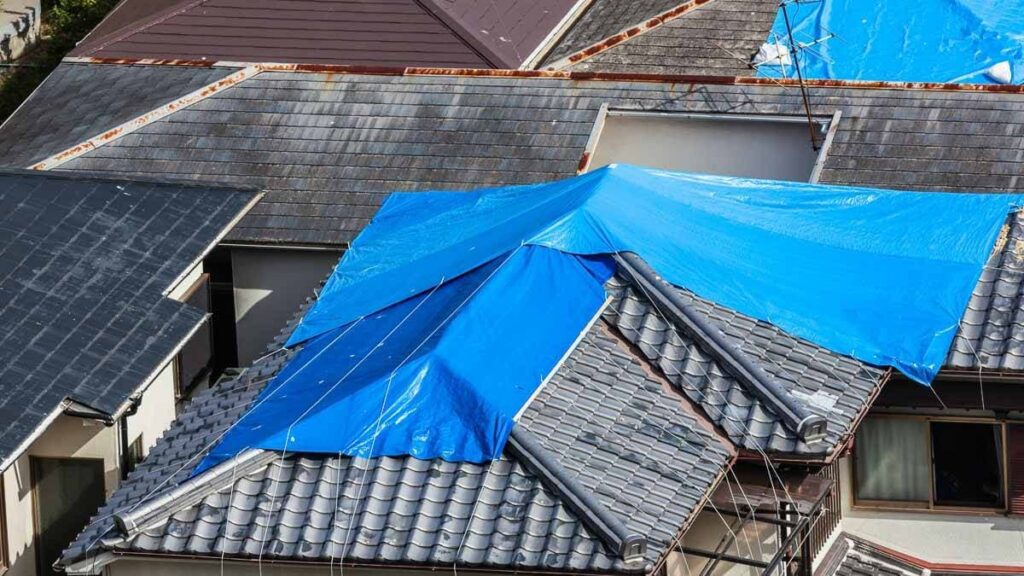 A residential roof tarped after a hail storm