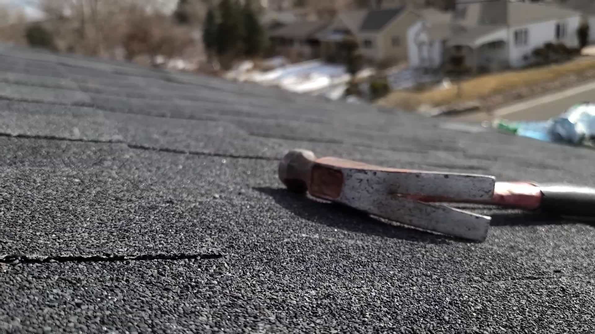 Hammer paying on asphalt shingles from a new job installed by 3O3 rooofer