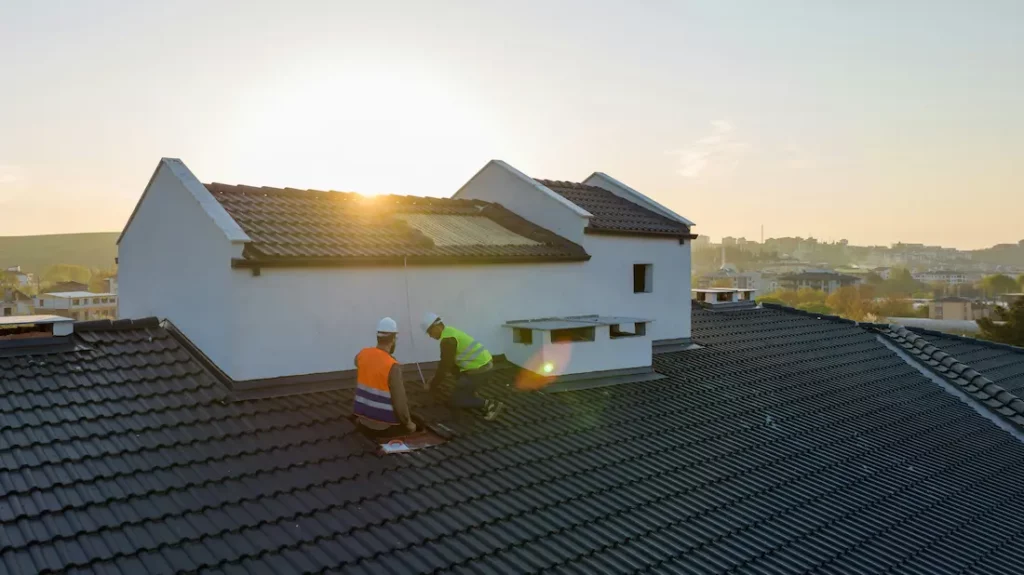 putting the final touches on a tile roof